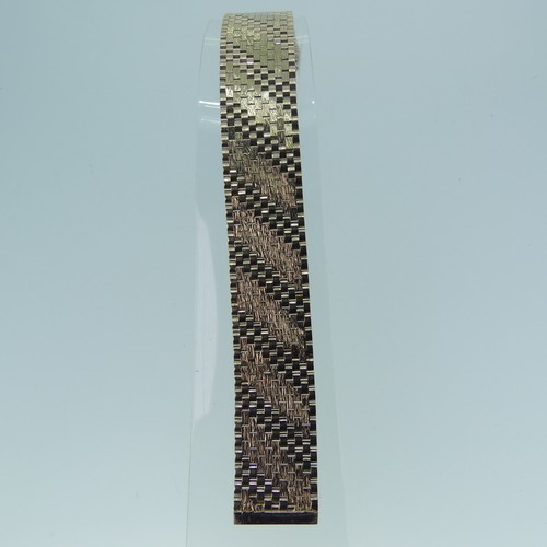 411 - A 9ct gold flexible brick link Necklace, the eleven rows in bands of alternate polished and textured... 