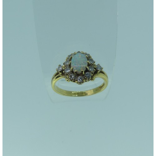 336 - An opal and diamond cluster Ring,the oval central opal approx. 7.1mm long, with ten diamonds around ... 