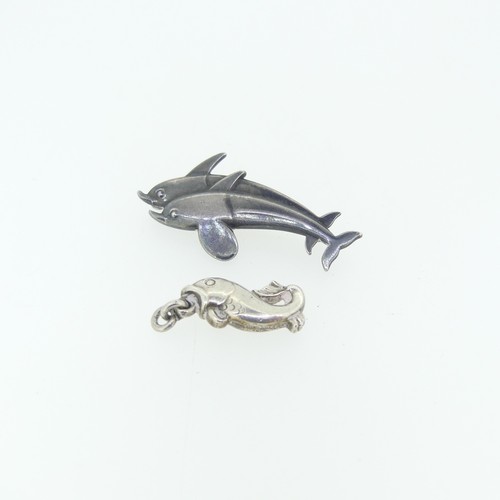 442 - Georg Jensen; A silver double Dolphin Brooch, design no. 317, 4cm long, together with a small Jensen... 