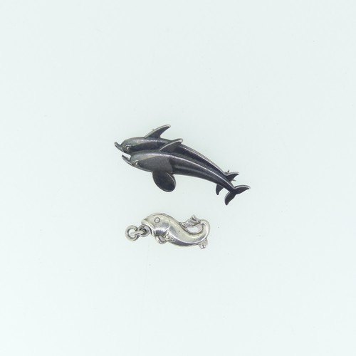 442 - Georg Jensen; A silver double Dolphin Brooch, design no. 317, 4cm long, together with a small Jensen... 