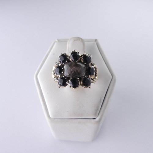 340 - An early 19thC Mourning Ring, with central hairset box and glass surrounded by eight facetted circul... 