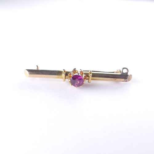 512 - A 15ct gold Bar Brooch, set central seed pearl and with a ruby at either end, metal pin, 3.1g, toget... 