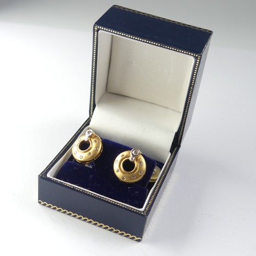 446 - A pair of 18ct yellow gold and diamond Earrings, of open circular form in brushed gold, two collet s... 