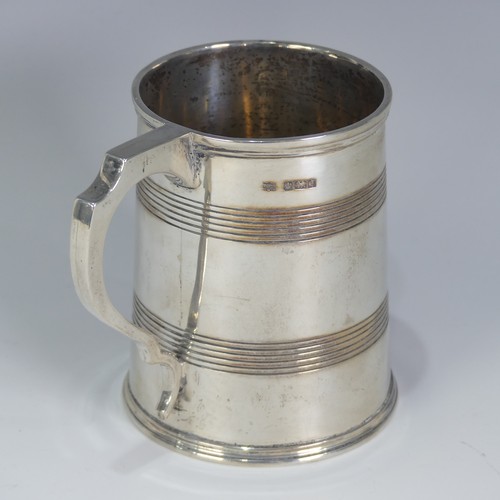 187 - A George V silver Mug, by Mappin & Webb Ltd., hallmarked Sheffield, 1917, tapering with bands of... 