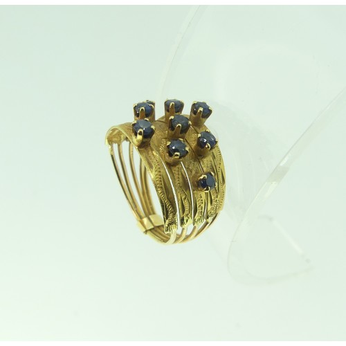 347 - An 18ct yellow gold multi strand Ring, the front claw set with nine small sapphires, Size M, approx.... 