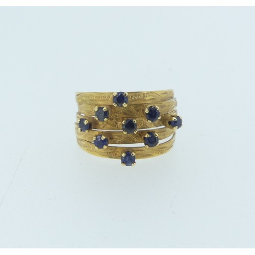 347 - An 18ct yellow gold multi strand Ring, the front claw set with nine small sapphires, Size M, approx.... 