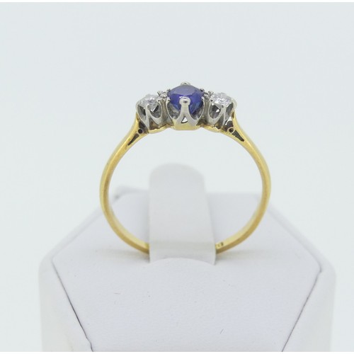 282 - A sapphire and diamond three stone Ring, the central oval facetted sapphire approx 4x4.6mm, with a c... 