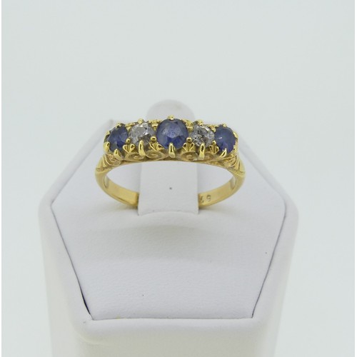 283 - A graduated sapphire and diamond five stone Ring, the central sapphire approx. 3.5mm diameter, all m... 