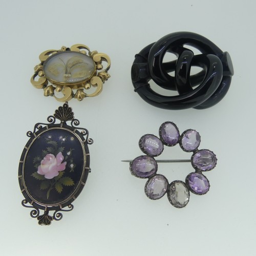 473 - A Pietra Dura Memorial Brooch, the oval panel with pink rose, in unmarked white metal framework moun... 