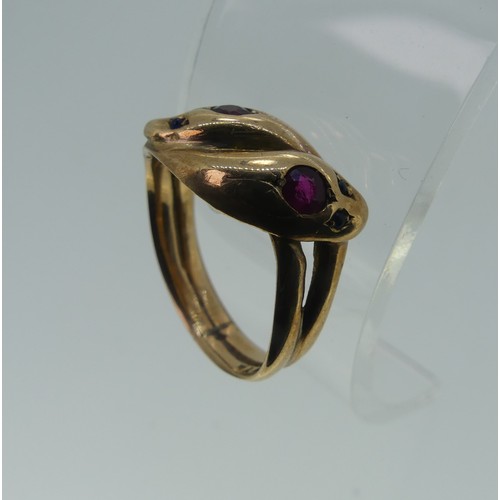 321 - An antique 9ct rose gold double snakes head Ring, the heads each set ruby and with two sapphire eyes... 