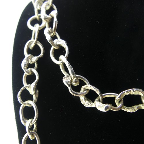 366 - Graham Watling; A silver Necklace, a continuous chain of abstract circular links, hallmarked for Jan... 