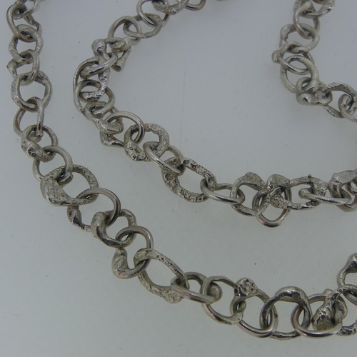 366 - Graham Watling; A silver Necklace, a continuous chain of abstract circular links, hallmarked for Jan... 