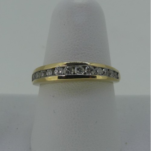 333 - A diamond set half hoop Eternity Ring, the thirteen graduated small diamonds channel set in 9ct yell... 