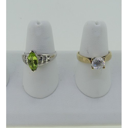 335 - A 9ct white gold Ring, set with a facetted navette shaped peridot, Size N, together with a cubic zir... 