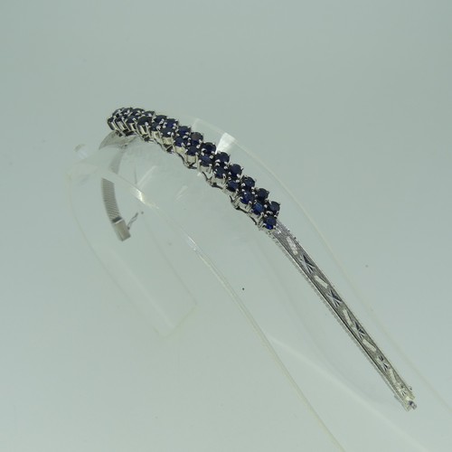 410 - A 9ct white gold mesh Bracelet, the front claw set with two rows of circular sapphires, marked 375 o... 