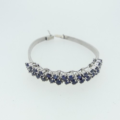 410 - A 9ct white gold mesh Bracelet, the front claw set with two rows of circular sapphires, marked 375 o... 