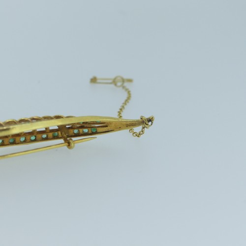 448 - A 9ct yellow gold Leaf Brooch, pierced and with two rows of small emeralds, 7cm long, approc weight ... 