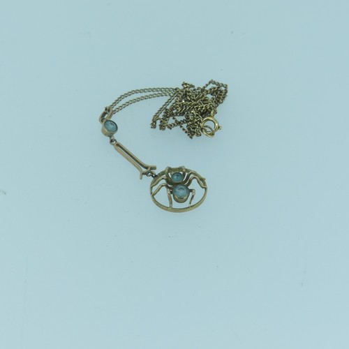 352 - A small Edwardian 9ct gold spider Pendant, the open circular pendant drop with central spider set tw... 