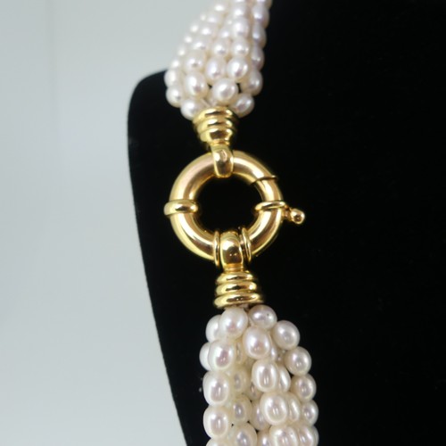 369 - A multistrand freshwater pearl Necklace, formed of eight rows of oval pearls, each approx. 5-6mm lon... 