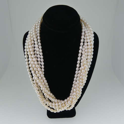 369 - A multistrand freshwater pearl Necklace, formed of eight rows of oval pearls, each approx. 5-6mm lon... 