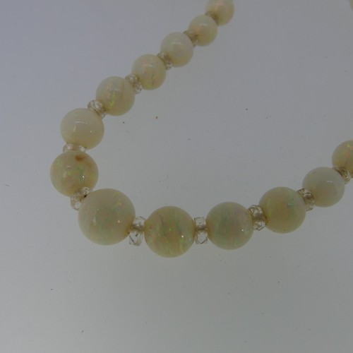 379 - A graduated opal bead Necklace, the white opals with facetted rock crystal spacers between each bead... 