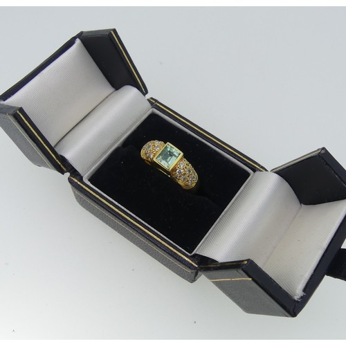 345 - An 18ct yellow gold, Topaz and diamond Dress Ring, the central rectangular facetted topaz, approx. 5... 