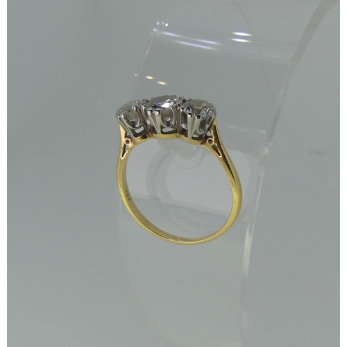 326 - A three stone diamond Ring, the centre circular stone approx 0.63ct, with a smaller stone one either... 