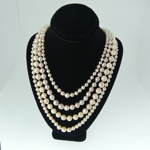 380 - A single row of baroque Cultured Pearls, on 9ct gold snap, 48cm long, together with a string of seed... 