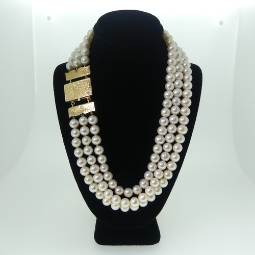 371 - A triple row cultured pearl choker Necklace, the uniform pearls each approx. 6.5-7mm diameter, on un... 