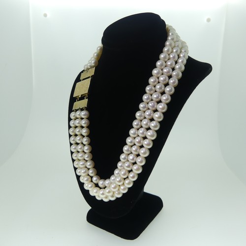 371 - A triple row cultured pearl choker Necklace, the uniform pearls each approx. 6.5-7mm diameter, on un... 