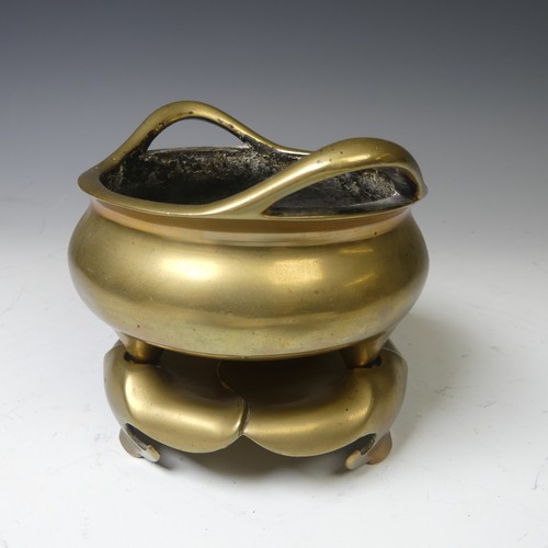 217 - A Chinese gilt bronze Tripod Censer, of typical circular form with two loop handles, raised on three... 