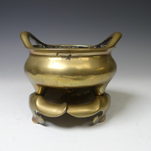 217 - A Chinese gilt bronze Tripod Censer, of typical circular form with two loop handles, raised on three... 