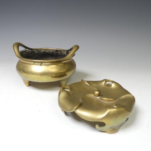 217 - A Chinese gilt bronze Tripod Censer, of typical circular form with two loop handles, raised on three... 