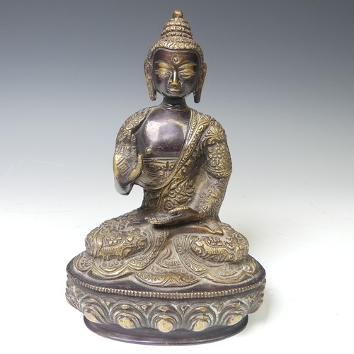 219 - An antique Sino-Tibetan gilt bronze figure of the Buddha, seated in dhyanasana on a lotus base, wear... 