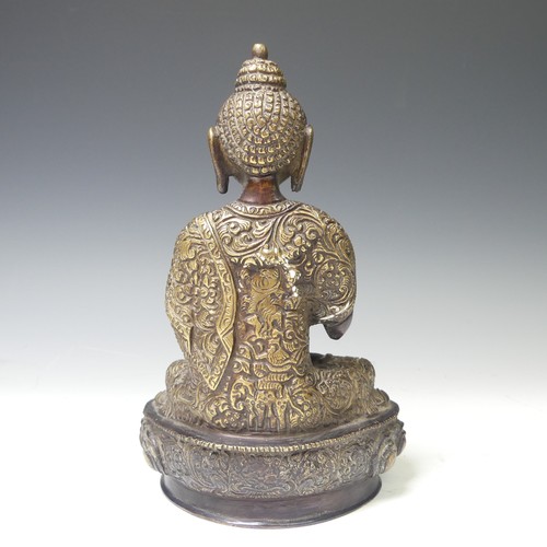 219 - An antique Sino-Tibetan gilt bronze figure of the Buddha, seated in dhyanasana on a lotus base, wear... 