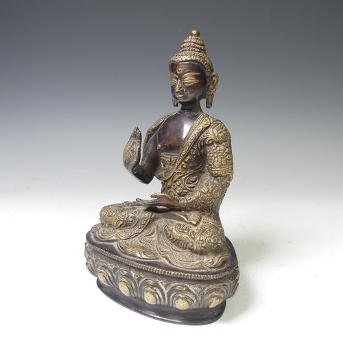 219 - An antique Sino-Tibetan gilt bronze figure of the Buddha, seated in dhyanasana on a lotus base, wear... 