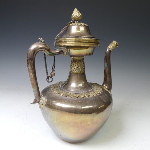 222 - A 19thC Tibetan silver and parcel-gilt ceremonial Teapot / Ewer, the plain tapering circular body wi... 