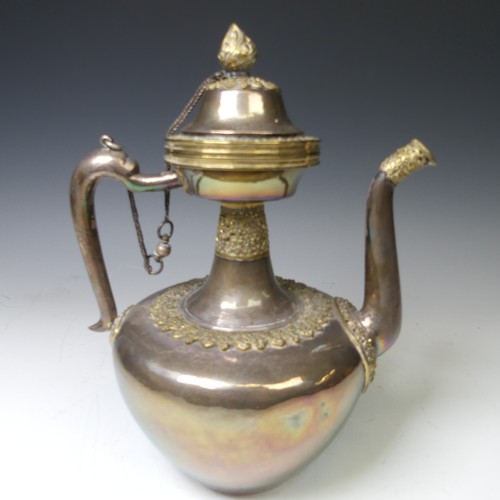 222 - A 19thC Tibetan silver and parcel-gilt ceremonial Teapot / Ewer, the plain tapering circular body wi... 