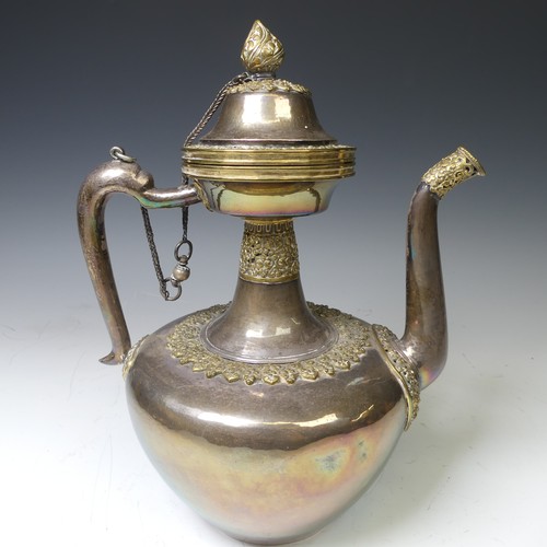 222 - A 19thC Tibetan silver and parcel-gilt ceremonial Teapot / Ewer, the plain tapering circular body wi... 