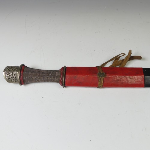 223 - A late 19thC Tibetan Sword, the single edged steel blade with pale shagreen grip and silver pommel, ... 