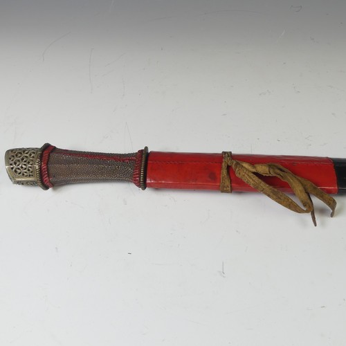 223 - A late 19thC Tibetan Sword, the single edged steel blade with pale shagreen grip and silver pommel, ... 