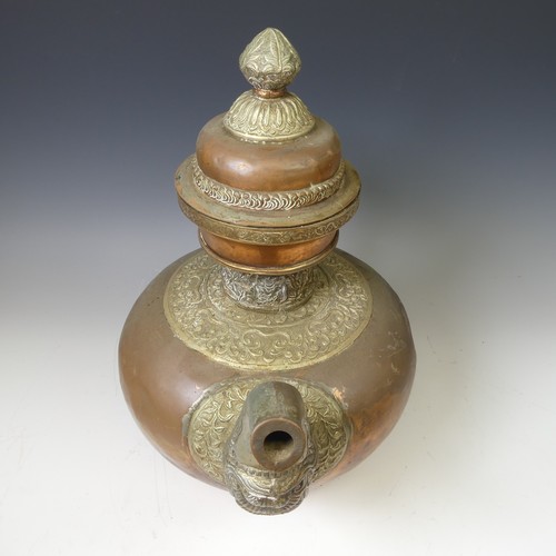 224 - A large Tibetan copper Tea Pot, with white metal mounts, the handle and spout modelled as a mythical... 