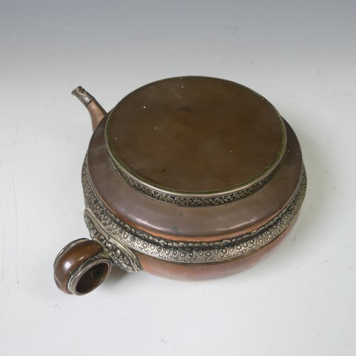 224 - A large Tibetan copper Tea Pot, with white metal mounts, the handle and spout modelled as a mythical... 