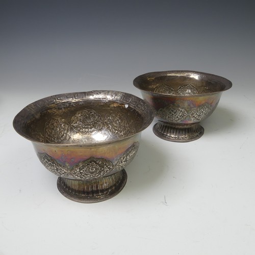 226 - A pair of Eastern circular silver Bowls, probably Tibetan, decorated with Buddhist symbolism and Gre... 