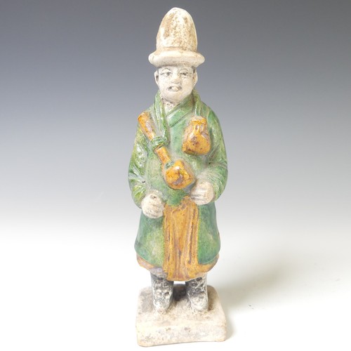 239 - A Chinese Ming dynasty pottery Figure, modelled as a male attendant figure, dressed in a dark green ... 