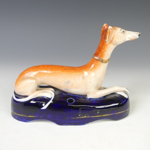 11 - A pair of 19thC Staffordshire Greyhounds, with pierced aperture for pen stand, together with another... 