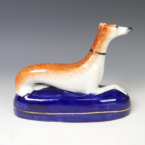 11 - A pair of 19thC Staffordshire Greyhounds, with pierced aperture for pen stand, together with another... 