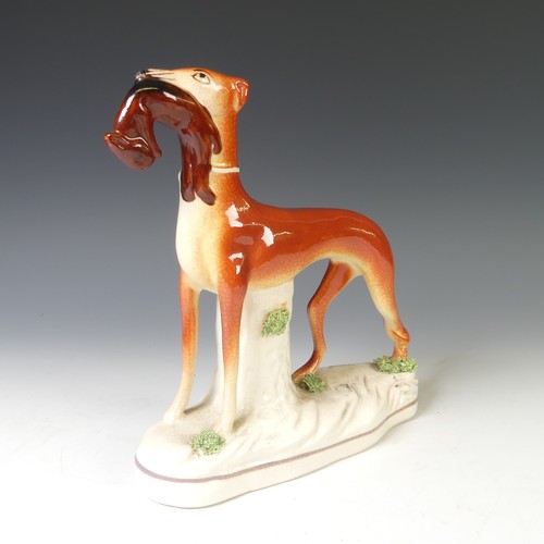 40 - An antique Staffordshire pottery group of a Cow with its Calf, raised on moulded plinth, together wi... 