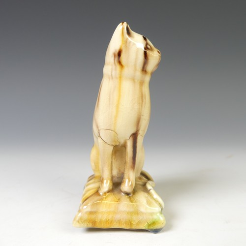 44 - A small 19thC creamware figure of a Cat, seated on rectangular plinth, decorated in Wheildon-type gl... 