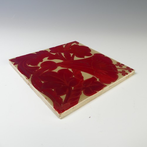 130 - A 20thC pottery Tile, in the style of William de Morgan, the cream ground with ruby lustre floral de... 